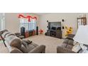 Cozy living room features plush seating, a large screen TV, and speaker system for entertainment at 1102 Tupelo Trl, Haines City, FL 33844