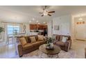 Cozy living room with comfortable sofas, open to a dining area and a modern kitchen at 1158 Legatto Loop, Dundee, FL 33838