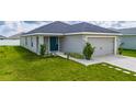 Charming single-story home featuring a spacious two-car garage and a well-manicured lawn at 1719 Daystar Dr, Haines City, FL 33844