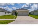 Charming single-story home featuring a spacious two-car garage and a well-manicured lawn at 1719 Daystar Dr, Haines City, FL 33844