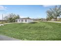 A single story house features a well-maintained lawn and clear skies, conveying a sense of peace and neatness at 2 Dogwood Radl, Ocala, FL 34472