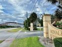 Entrance sign that reads 'Royale Bermuda' near a bridge with green grass around the area at 2031 Balboa Way, Kissimmee, FL 34741