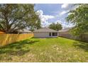 Spacious backyard enclosed by a wooden fence and lush green grass, great for outdoor activities at 2146 Fish Eagle St, Clermont, FL 34714