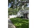Well-maintained home with lovely curb appeal, featuring green lawn and decorative fence along the property line at 2225 Maryday Ct, Orlando, FL 32812