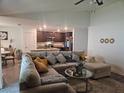 Spacious living room featuring a cozy sectional couch, providing a comfortable area for relaxation and entertaining at 2309 Rio Grande Forest Ln, Kissimmee, FL 34759
