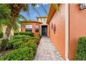 Charming home with brick walkway surrounded by lush landscaping with a blue front door at 271 Indian Wells Ave, Poinciana, FL 34759