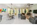 Bright living room with tile floors, large windows, and a dining area at 271 Indian Wells Ave, Poinciana, FL 34759
