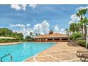 Resort-style community pool with inviting lounge chairs and lush tropical landscaping on a sunny day at 3162 Rodrick Cir, Orlando, FL 32824