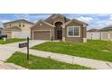 Attractive home with a well manicured lawn, attached two car garage and a classic mailbox near the curb at 326 Highland Meadows Ave, Davenport, FL 33837