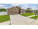 Single-Gathering home boasting a two-car garage, tidy landscaping, and a long driveway at 326 Highland Meadows Ave, Davenport, FL 33837