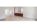 Bright, open-concept living area flows into the kitchen with wood-look flooring throughout at 3621 Devonswood Dr, Orlando, FL 32806