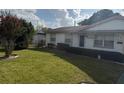 A well-maintained front yard with lush green grass and mature landscaping frames the home's facade at 4339 Solomon Dr, Orlando, FL 32811
