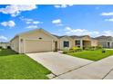 Beautiful single-story home boasts a lush green lawn and a spacious two-car garage at 4492 Bluff Oak Loop, Kissimmee, FL 34746