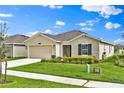 Attractive single-story house with a lovely landscaped front yard and a convenient two-car garage at 4492 Bluff Oak Loop, Kissimmee, FL 34746