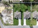 Aerial view of two identical properties with green lawns and long driveways at 4613 Madison Ave, Lake Wales, FL 33859