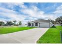 Beautiful single-story home featuring a lush green lawn and long driveway at 4613 Madison Ave, Lake Wales, FL 33859