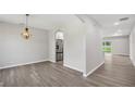 Open concept dining room with modern chandelier and archways at 4615 Madison Ave, Lake Wales, FL 33859