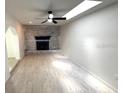 Spacious living room with a decorative brick fireplace, recessed lighting, and neutral paint at 5249 Se 106Th Ln, Belleview, FL 34420