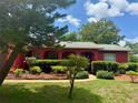 Charming single-story home with a well-maintained lawn and colorful landscaping around the front entrance at 6478 Inca St, Orlando, FL 32807