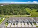 Aerial view of townhomes surrounded by lush trees, showcasing community living at 7685 Stone Creek Trl, Kissimmee, FL 34747
