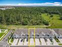 Aerial view of townhomes surrounded by lush trees, showcasing community living at 7685 Stone Creek Trl, Kissimmee, FL 34747