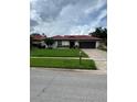 Beautiful single-story home with a red tile roof, green lawn, and a charming exterior at 8057 Marcella Dr, Orlando, FL 32836