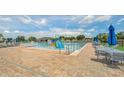 Large community pool with slides, splash features, lounge chairs, and umbrellas for residents' enjoyment at 911 Mendoza Ln, Kissimmee, FL 34758