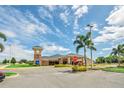 A well-maintained building complex with lush landscaping, ample parking, and a prominent clock tower feature at 911 Mendoza Ln, Kissimmee, FL 34758