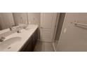 Bathroom featuring double sinks, modern fixtures, and a neutral color palette at 9414 Haber Ct, Orlando, FL 32827