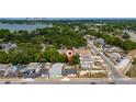 Aerial view of a residential area with tree-lined streets and a house with a red marker for location at 1009 S Ivey Ln, Orlando, FL 32811