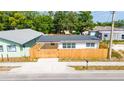 Charming single-story home featuring a well-maintained lawn and a classic wood fence enhancing curb appeal at 1009 S Ivey Ln, Orlando, FL 32811