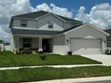 Charming two-story home with a manicured lawn and inviting curb appeal at 1016 Cascade Dr, Davenport, FL 33837