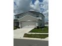 Two-story home with a two-car garage and well-kept lawn at 1016 Cascade Dr, Davenport, FL 33837