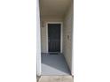 A solid black front door is framed by white trim, creating a clean and inviting entrance at 1023 S Hiawassee Rd # 4017, Orlando, FL 32835