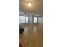 Bright living room featuring tile flooring, neutral paint, and ample natural light from large windows at 1023 S Hiawassee Rd # 4017, Orlando, FL 32835