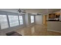 Bright living room with ceiling fans, tile flooring, and lots of natural light from large windows at 1023 S Hiawassee Rd # 4017, Orlando, FL 32835
