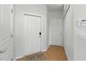 Inviting hallway with multiple doors, neutral paint, and tile flooring providing ample storage at 1225 Bella Cara Ct # 1, Davenport, FL 33896
