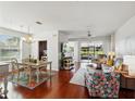 Open-concept living room and dining area with hardwood floors and plenty of natural light at 1225 Bella Cara Ct # 1, Davenport, FL 33896