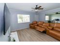 Relaxing living room with wood-look floors, ceiling fan, and large leather sofa, perfect for entertaining at 139 Oyster Bay Cir # 200, Altamonte Springs, FL 32701