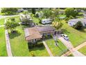Aerial view of the home showcasing the backyard, solar panels, and surrounding neighborhood at 1566 Providence Blvd, Deltona, FL 32725