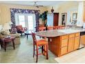 Inviting living area featuring a breakfast bar, elegant furnishings, and sliding doors to the lanai at 1592 Heritage Crossing Ct # 202, Reunion, FL 34747