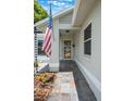 Inviting front entrance with tiled walkway and decorative front door, showcasing curb appeal at 1631 Woodbay Ct, Kissimmee, FL 34744