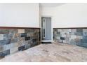 Charming entryway with stone walls and flooring, leading to the front door at 1870 Brentwood Ct, Davenport, FL 33837