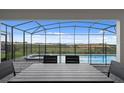 An inviting outdoor living space, showcasing a screened-in pool, spa, and patio for outdoor relaxation at 2176 Lelani Cir, Davenport, FL 33897