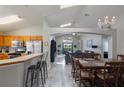 Open floorplan showcasing the kitchen, dining area, and living room, all with bright natural light at 2685 Oneida Loop, Kissimmee, FL 34747