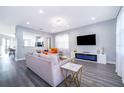 Bright, modern living room featuring stylish furniture, sleek flooring, and a contemporary fireplace with blue ambient lighting at 321 Lasso Dr, Kissimmee, FL 34747