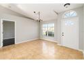 Bright foyer featuring tile flooring, large windows, and a modern light fixture at 4215 Red Bird Ave, St Cloud, FL 34772