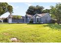 Lovely single-story home with lush lawn and mature landscaping at 4215 Red Bird Ave, St Cloud, FL 34772