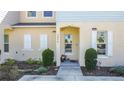 Inviting townhome with a landscaped front yard, shutters, and a covered entryway at 4850 Coral Castle Dr, Kissimmee, FL 34746