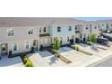 A row of modern townhomes, each with a driveway and neat landscaping in a Gathering-friendly community at 4850 Coral Castle Dr, Kissimmee, FL 34746